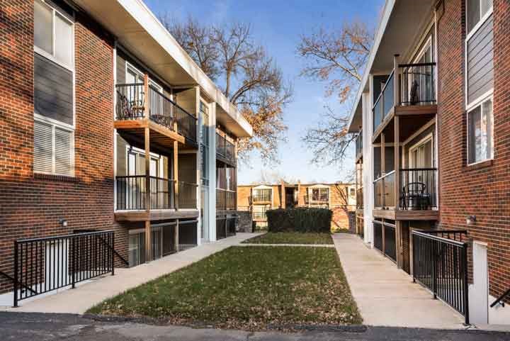 an apartment building with a yard in the middle