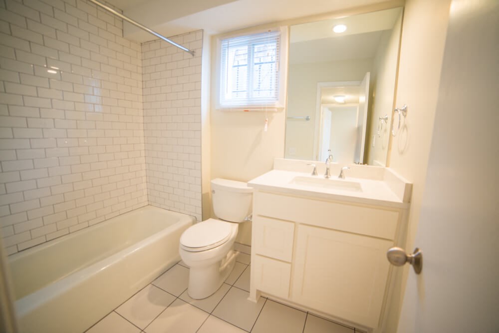a white bathroom with a toilet and a sink