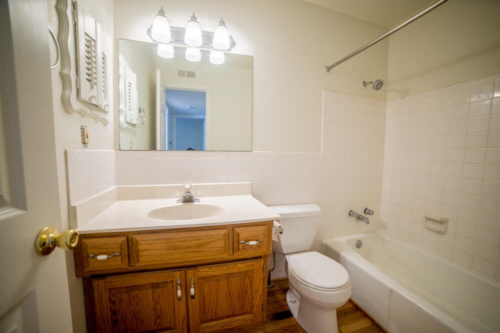 a bathroom with a sink toilet and a bath tub