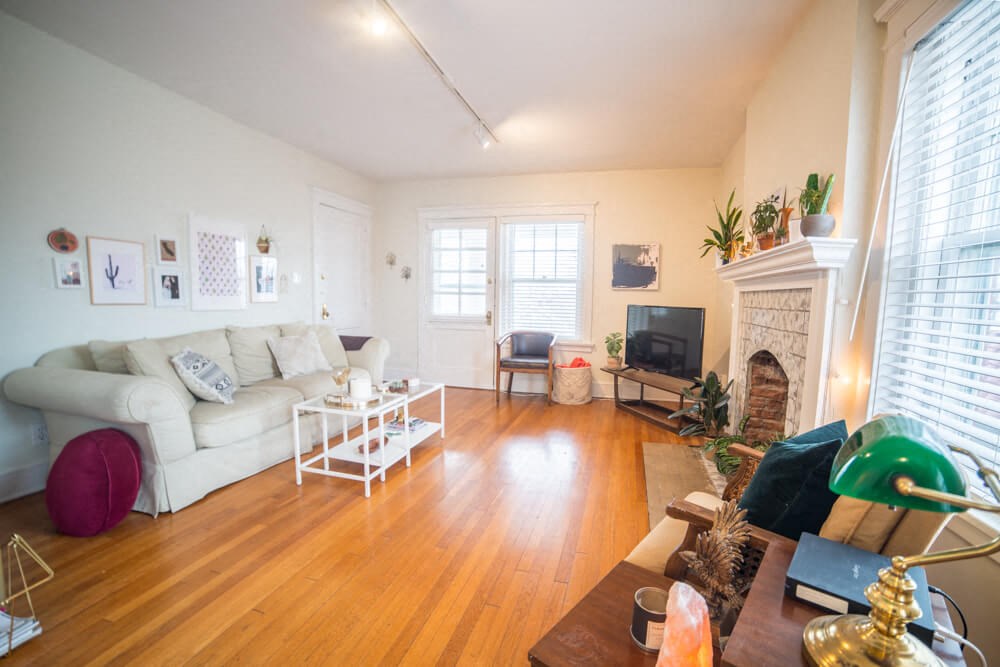 a living room with a white couch and a fireplace