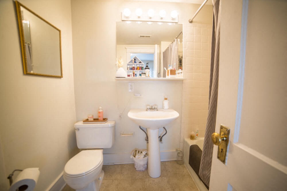 a small bathroom with a sink toilet and a mirror