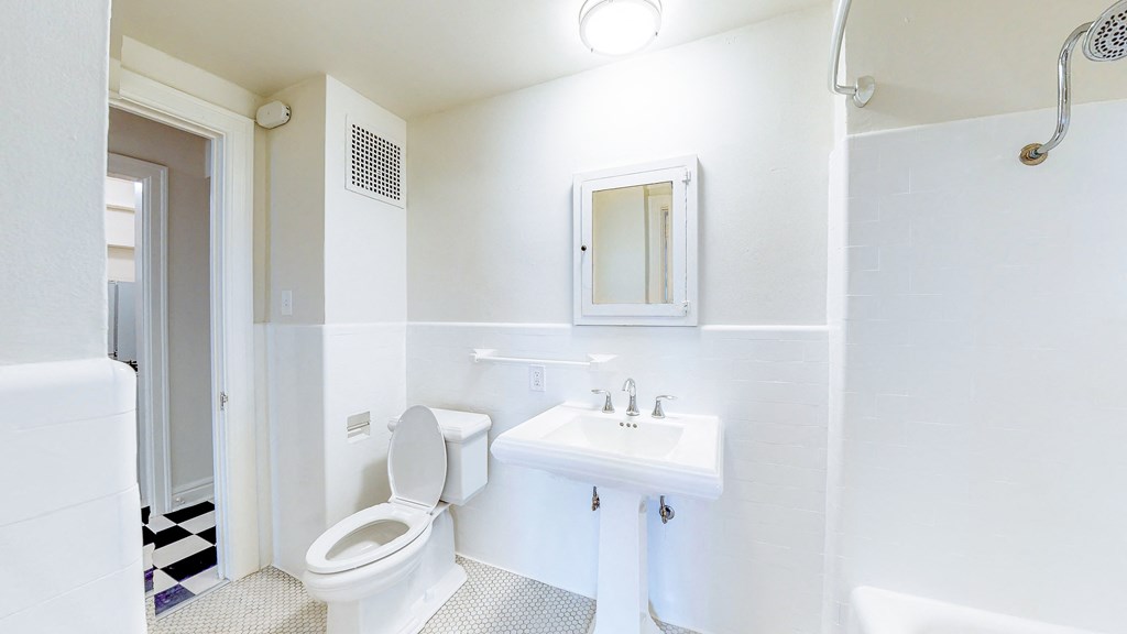 a bathroom with a sink toilet and a shower