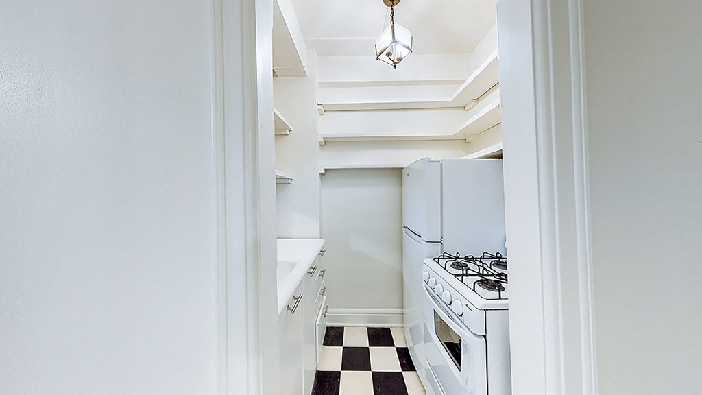a small kitchen with a stove and a refrigerator