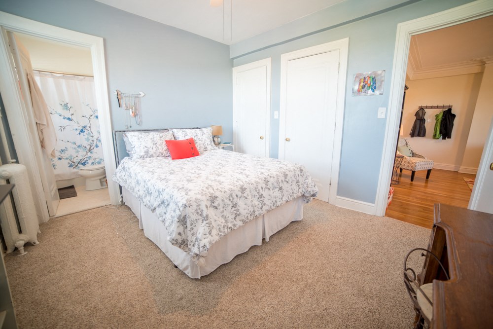 a bedroom with a bed and a closet