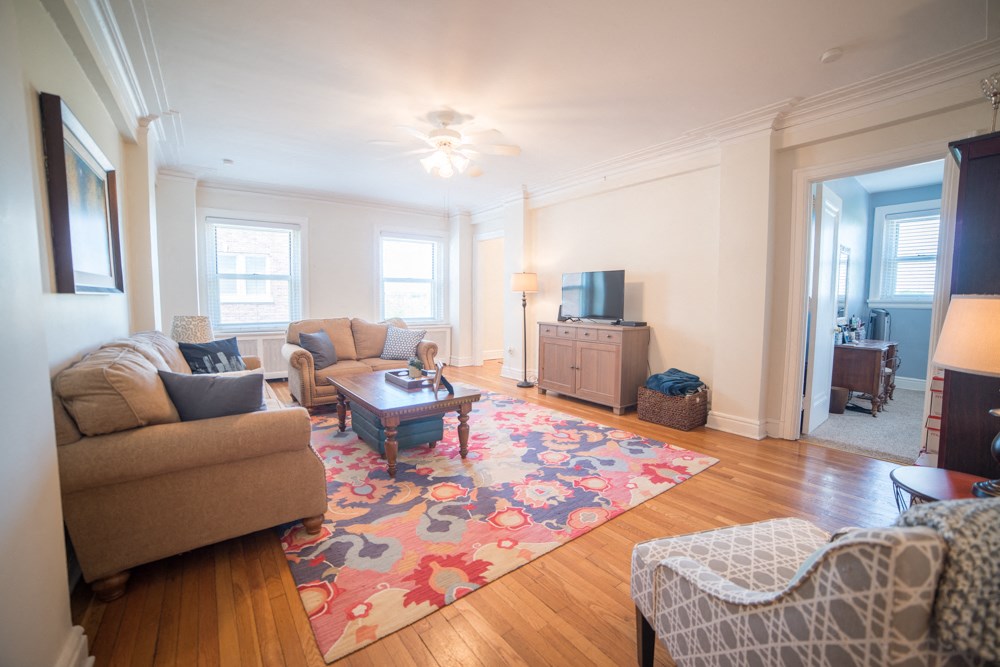 a living room with a couch and a coffee table and a tv