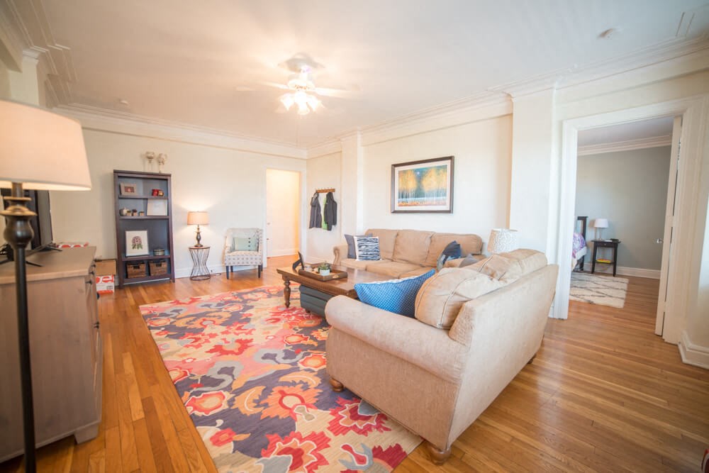 a living room with a couch and a rug