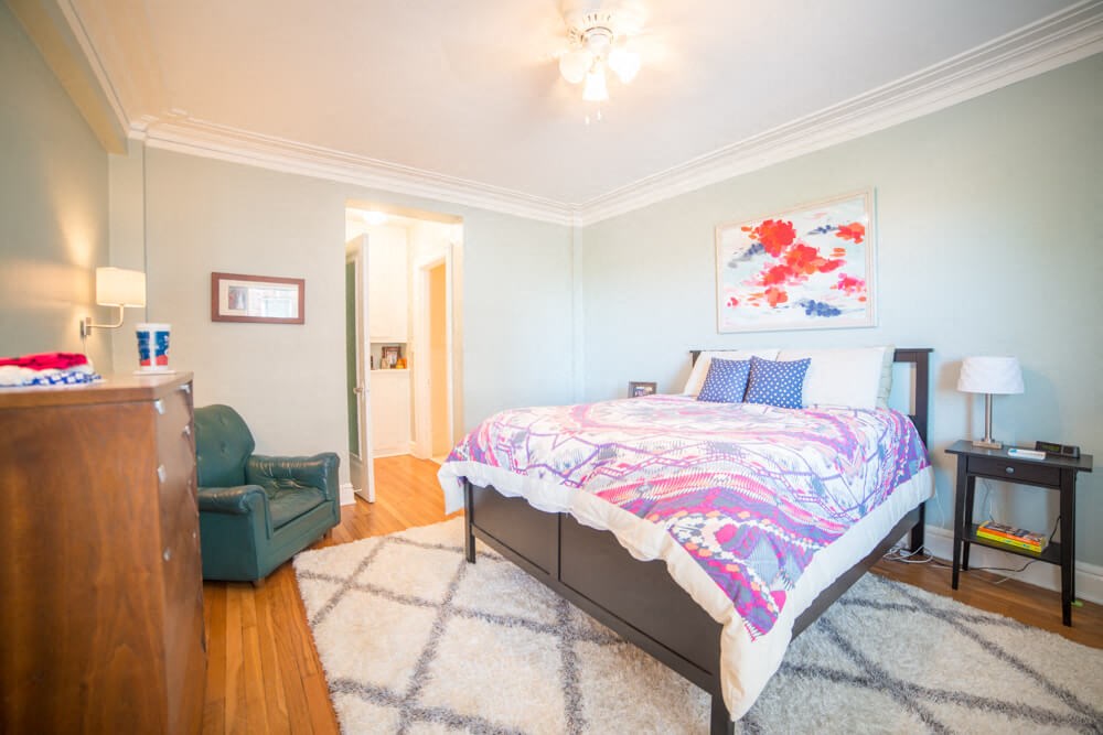 a bedroom with a bed and a chair