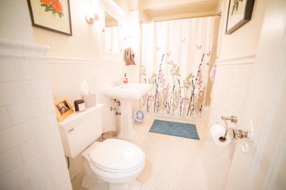 a white bathroom with a toilet sink and shower