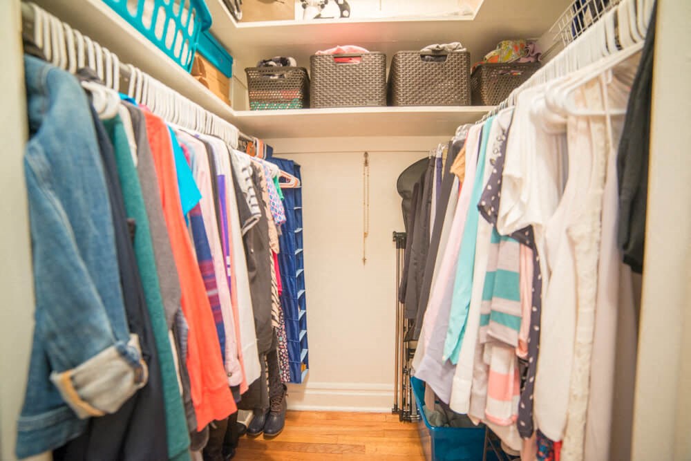 a rack of clothes in a closet