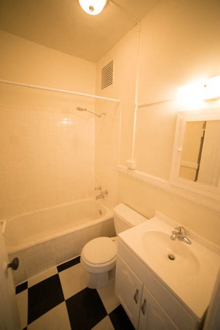 a white bathroom with a white toilet and a sink