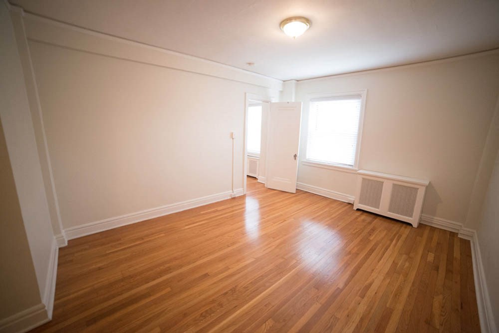 the living room of an empty house with a wooden floor