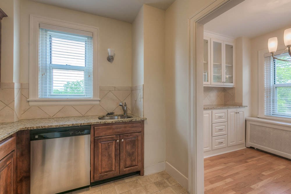 a kitchen with a dishwasher and a sink and a window