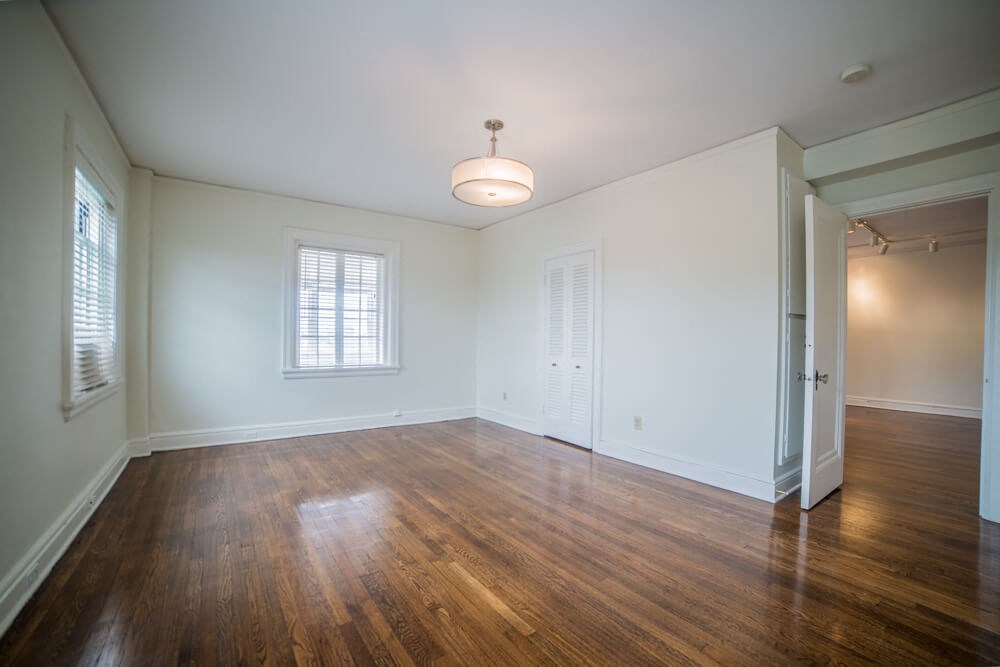 the living room of an empty house with a hard wood floor