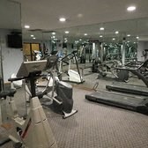 A gym with treadmills, exercise bikes and other equipment.
