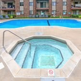 A swimming pool in front of a brick building.