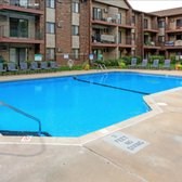 A swimming pool in front of apartment buildings.