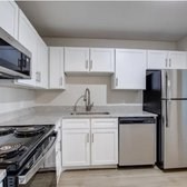 A kitchen with white cabinets and appliances.