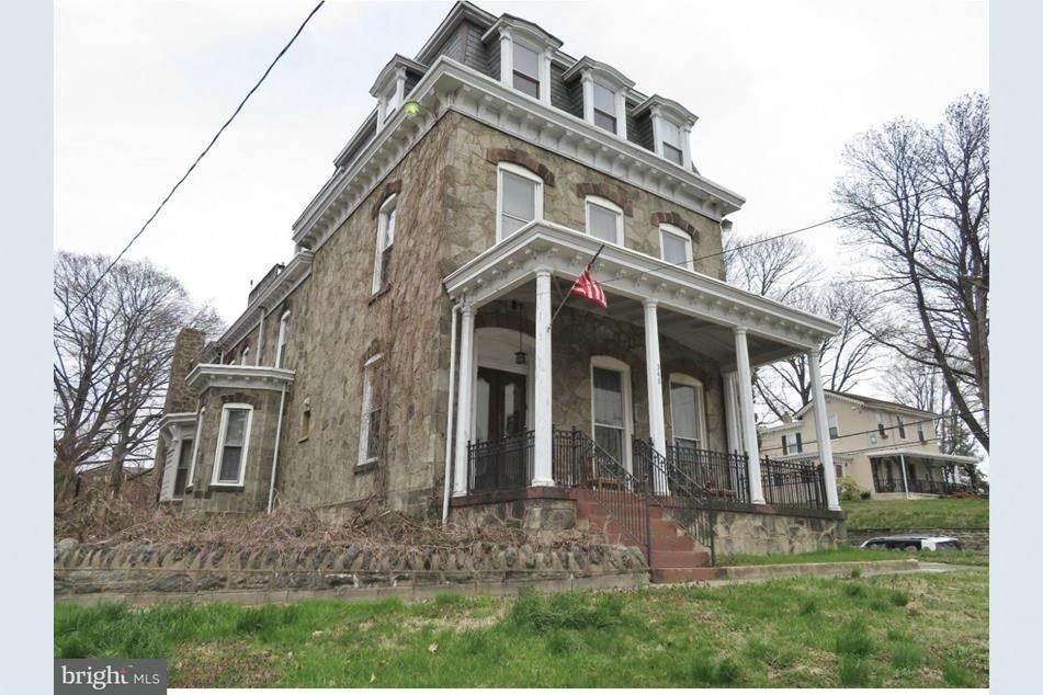 an old house with a flag on the front of it