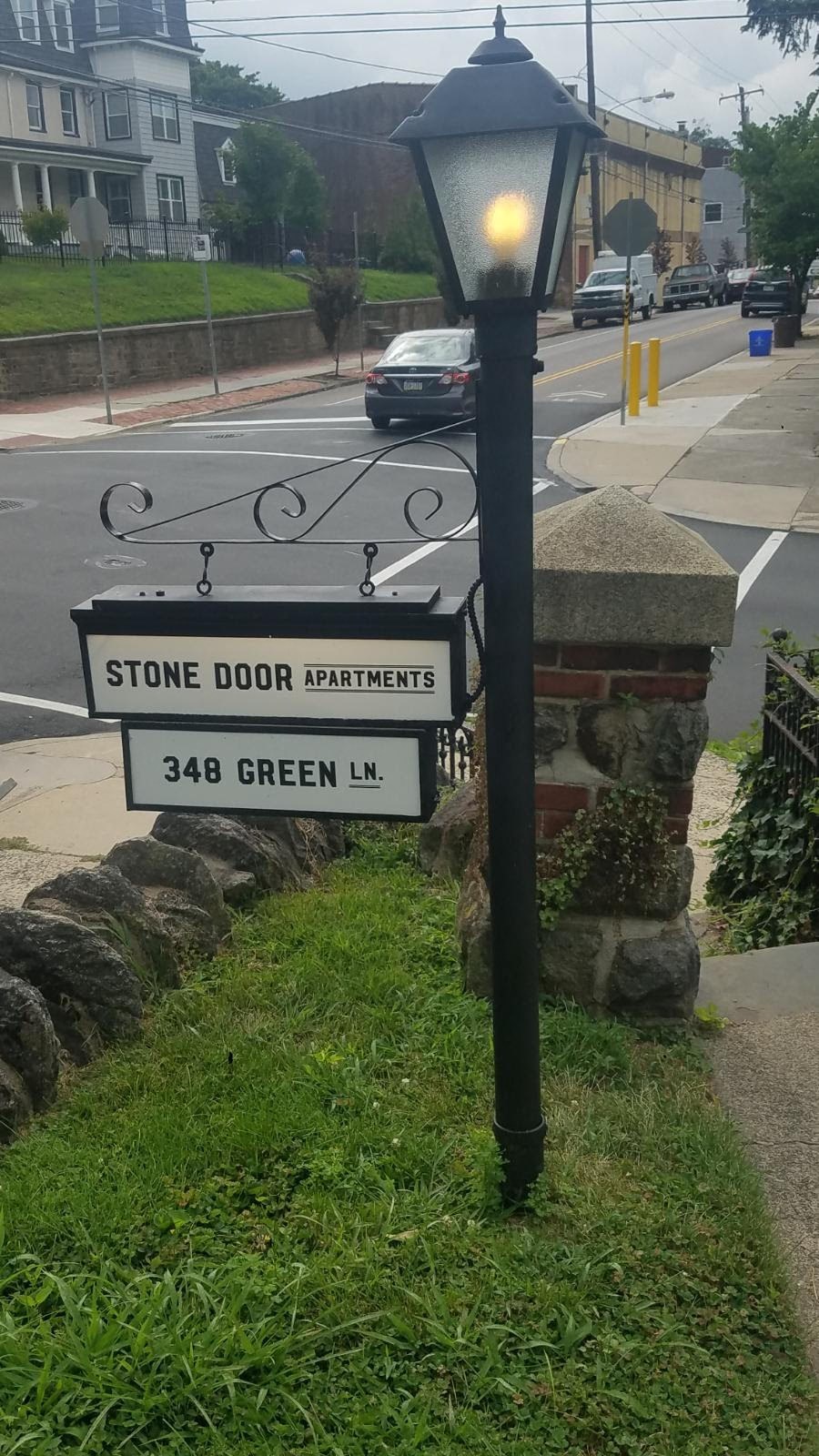 a street sign on the side of a street lamp