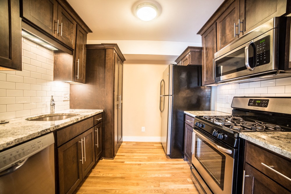 a kitchen with stainless steel appliances and wooden cabinets