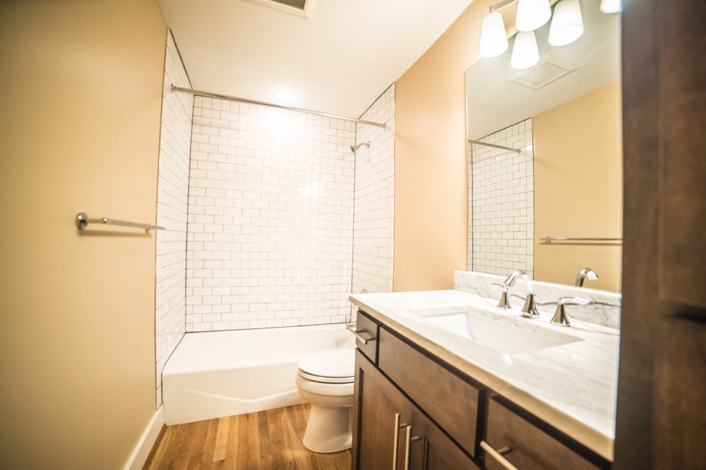 a bathroom with a sink and a toilet and a shower
