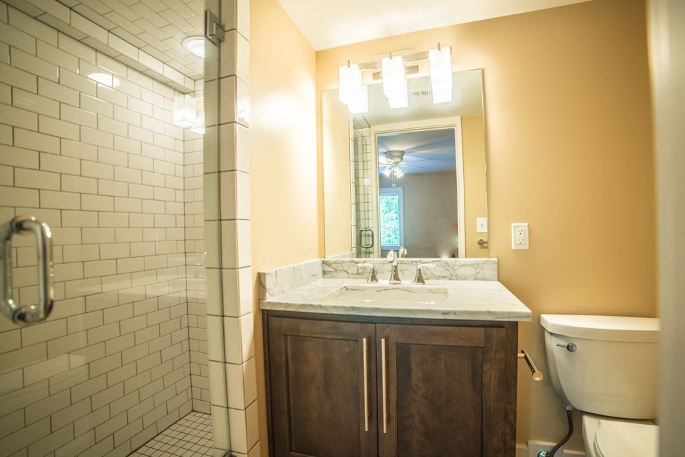 a bathroom with a sink and a shower and a toilet