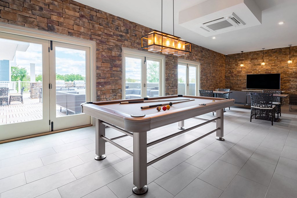 a game room with a pool table and a tv