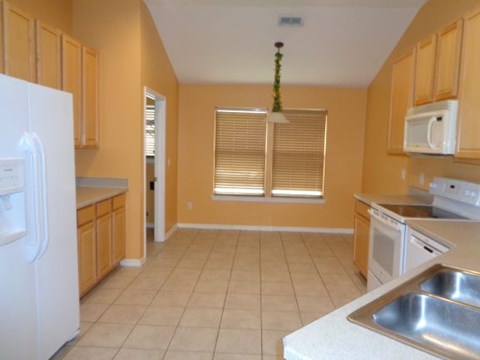 a large kitchen with a stove and a sink