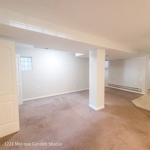 an empty living room with white walls and a concrete floor