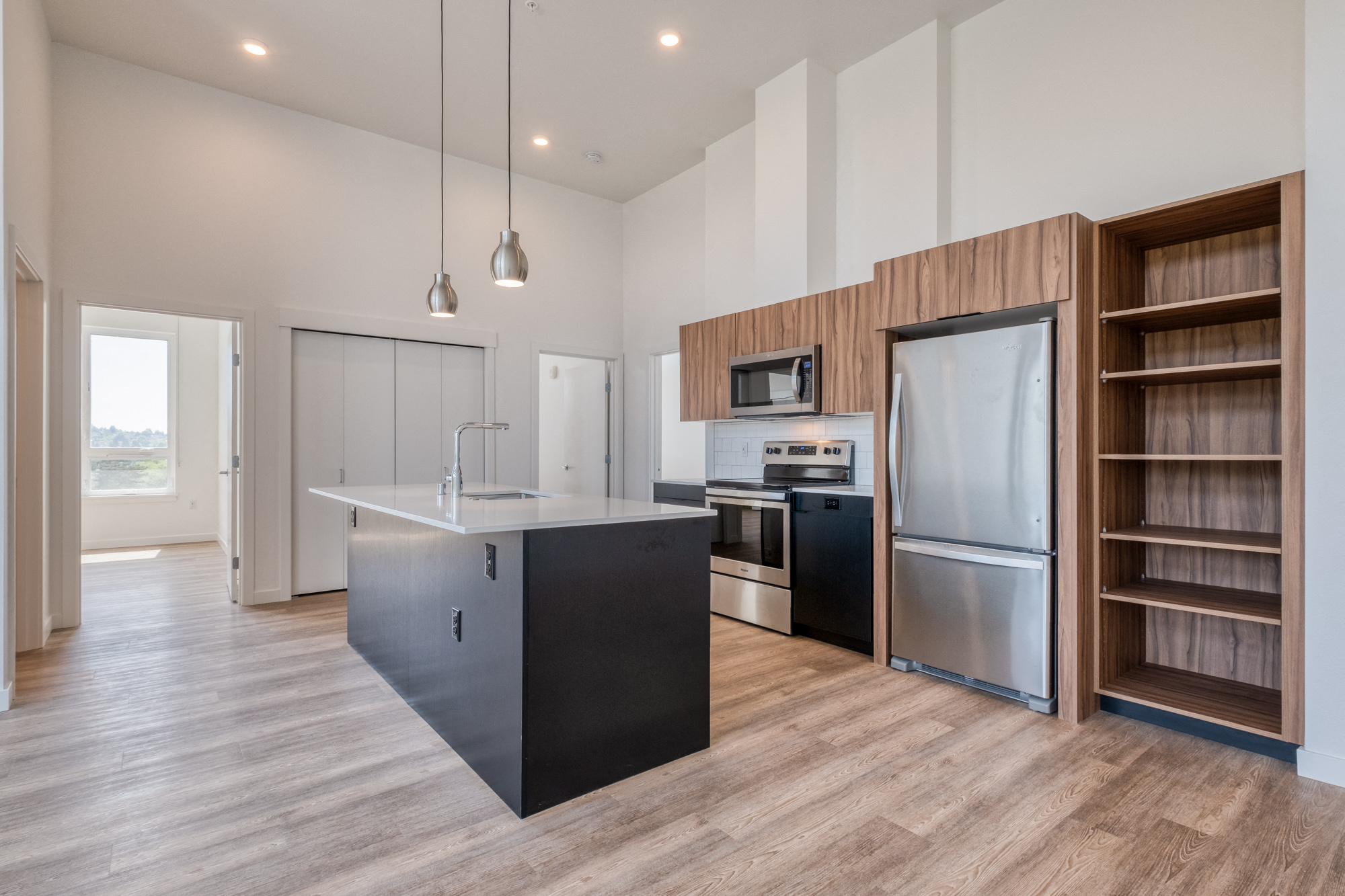 a kitchen with a large island and stainless steel appliances