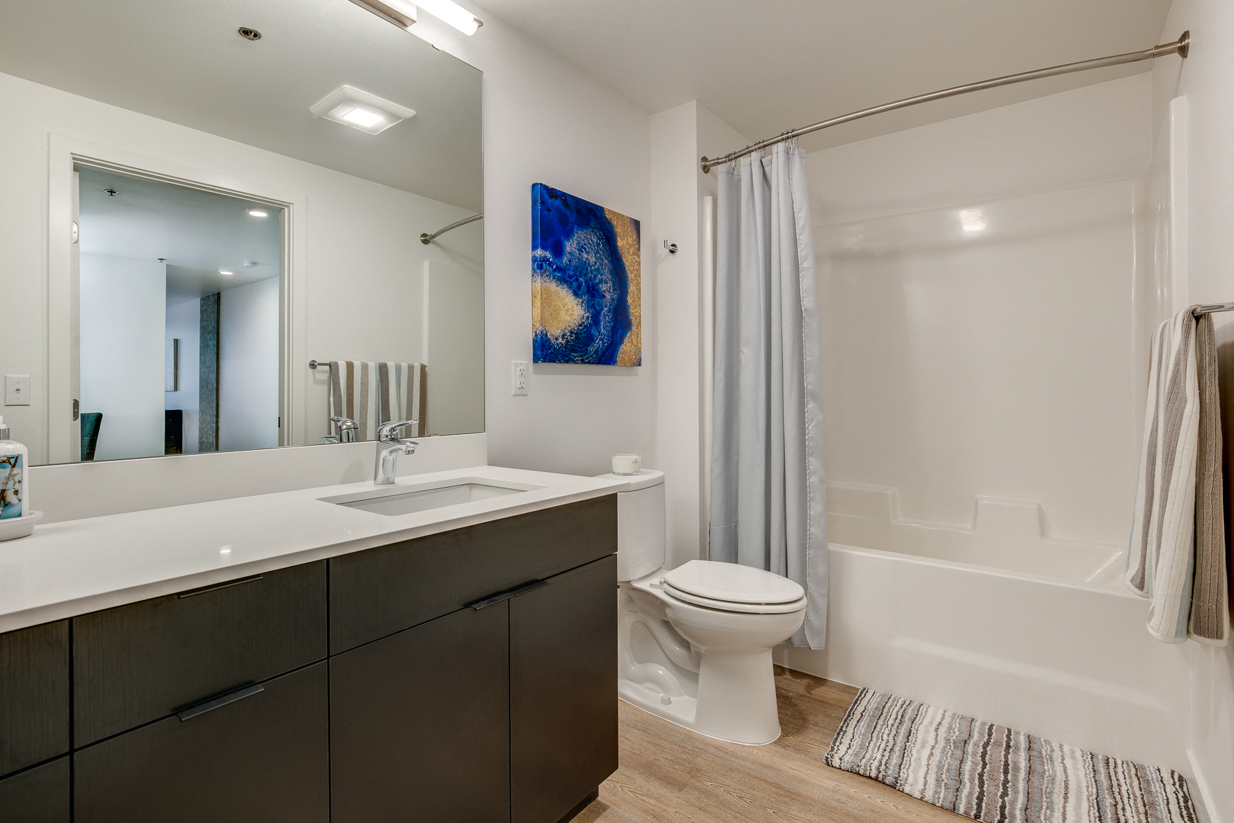 a bathroom with a shower toilet and sink and a mirror