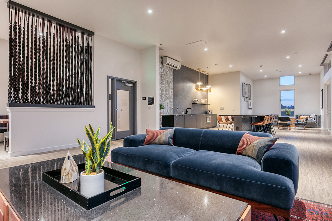 a living room with a blue couch and a coffee table