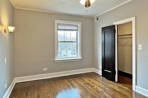 A room with a wooden floor and a black door.