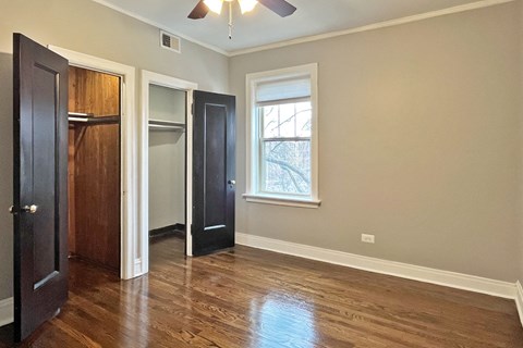 A room with a window and a ceiling fan.