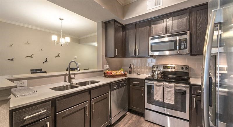 a kitchen with stainless steel appliances and a sink