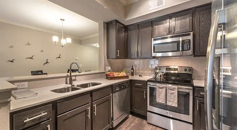 a kitchen with stainless steel appliances and a sink