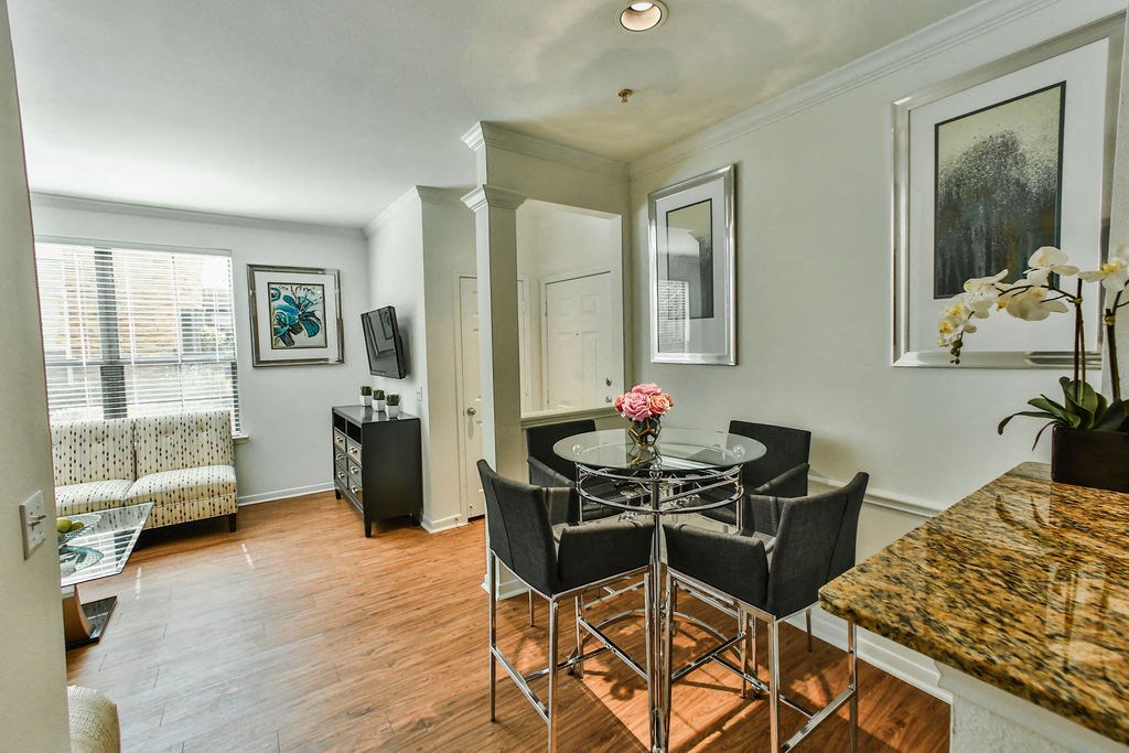 a dining room with a table and chairs and a living room