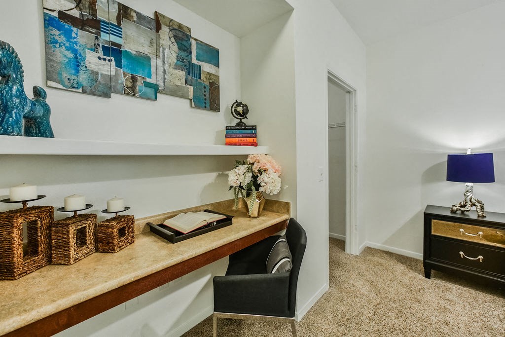 a home office with a desk and a chair and a mirror