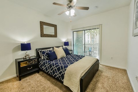 a bedroom with a bed and a ceiling fan