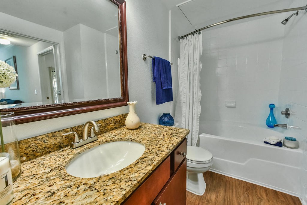a bathroom with a sink and a shower and a mirror
