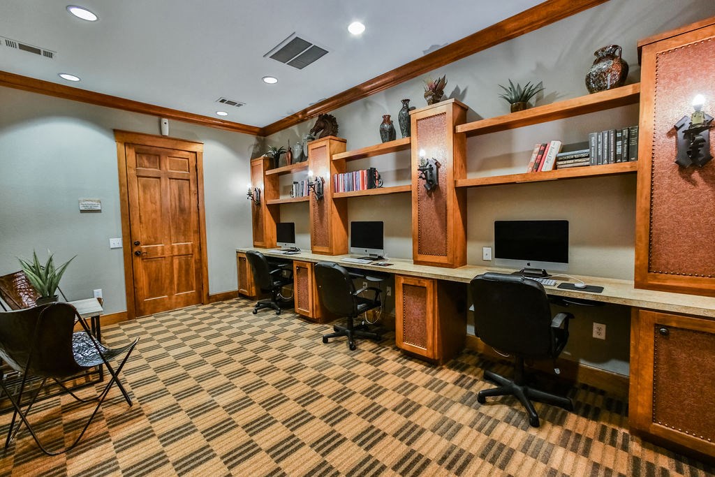 a home office with two desks and two computer monitors