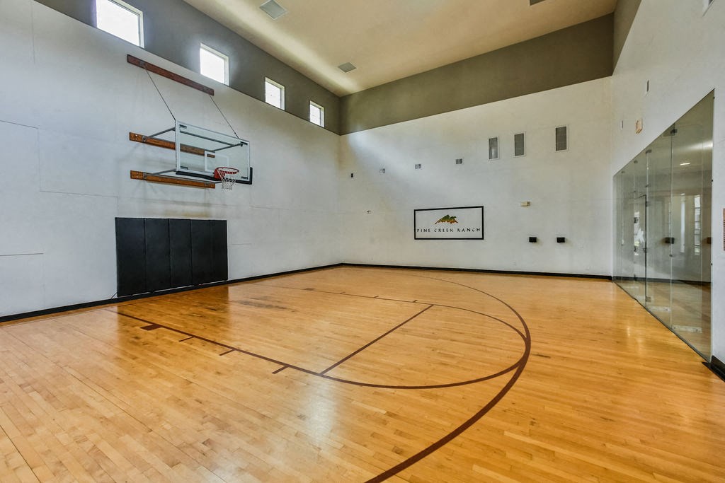 the gym has a hardwood floor and a basketball court