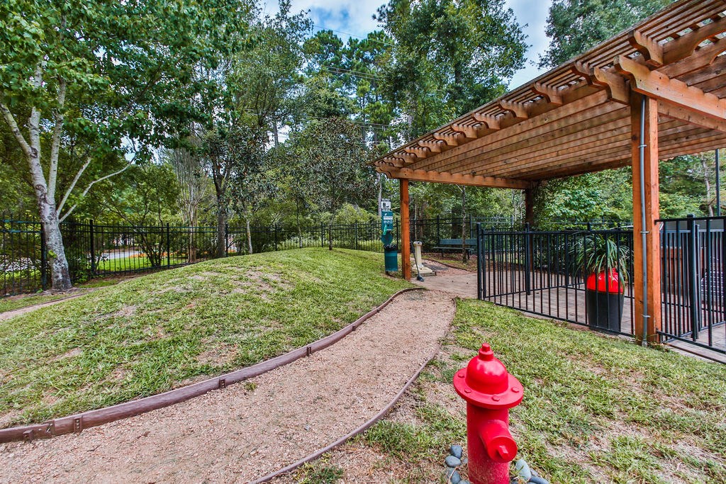 a red fire hydrant sitting next to a pavilion