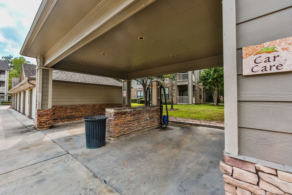 a gas station with a car care sign on the side of a building