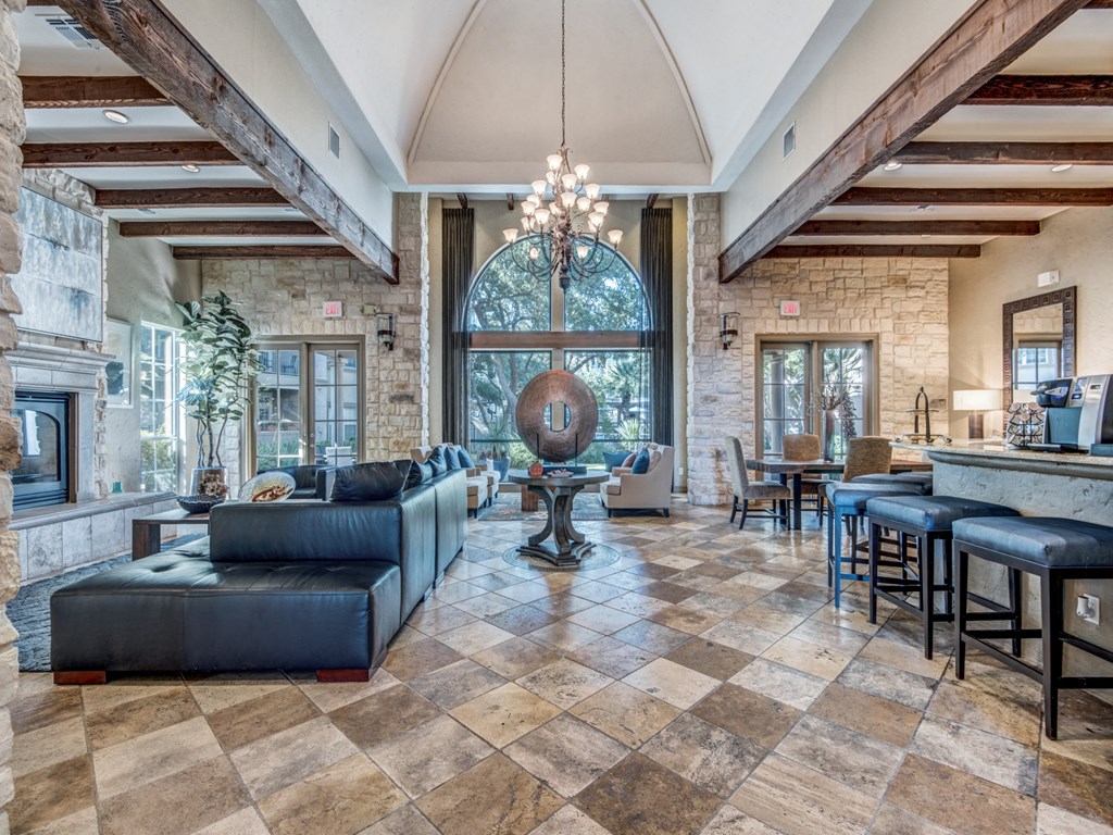 a large living room with a fireplace and a large glass door