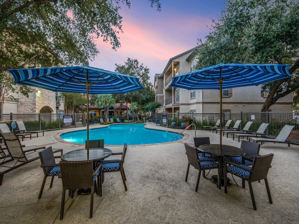 our apartments have a resort style pool with tables and umbrellas