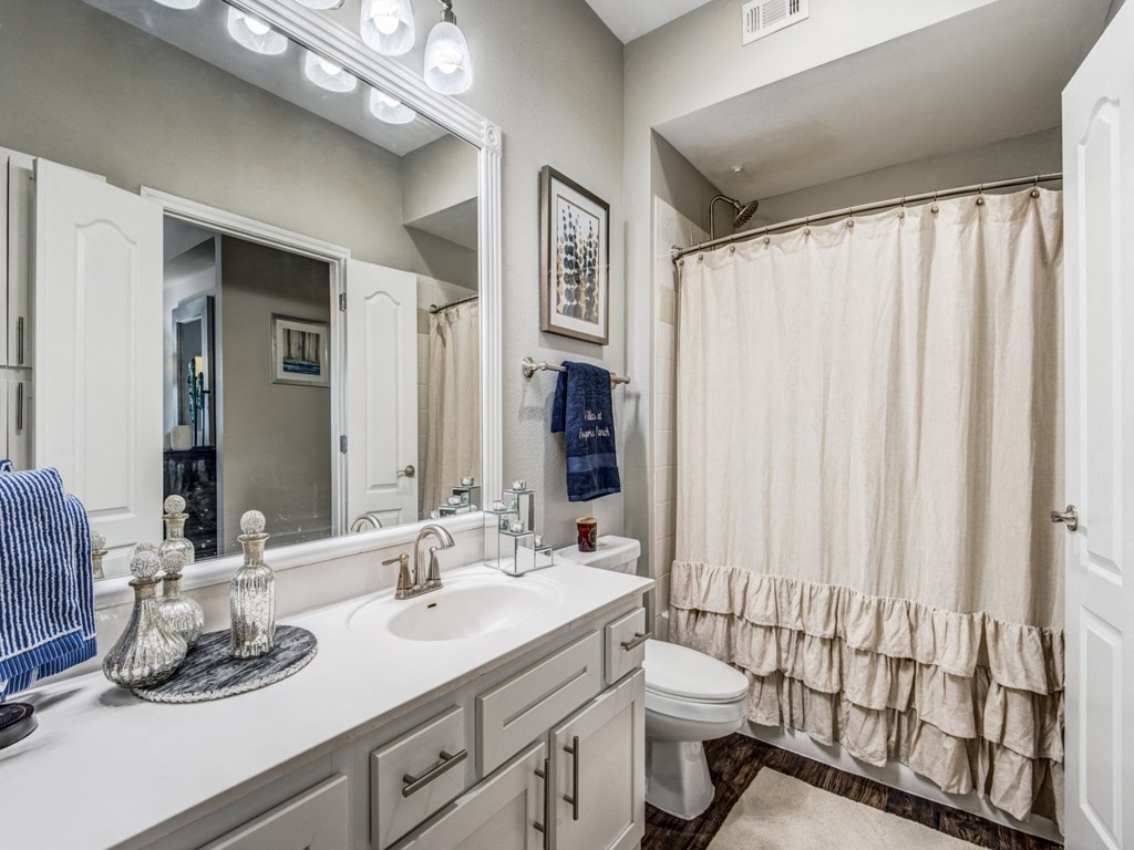 a bathroom with a shower and a sink and a toilet