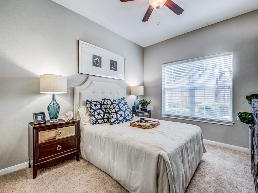 a bedroom with a bed and a ceiling fan