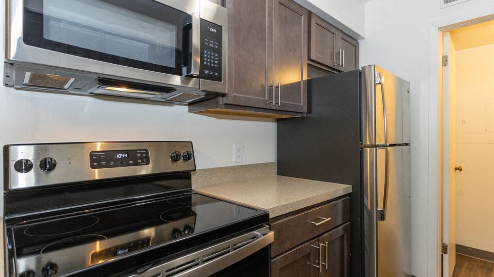 a kitchen with a stove microwave and refrigerator