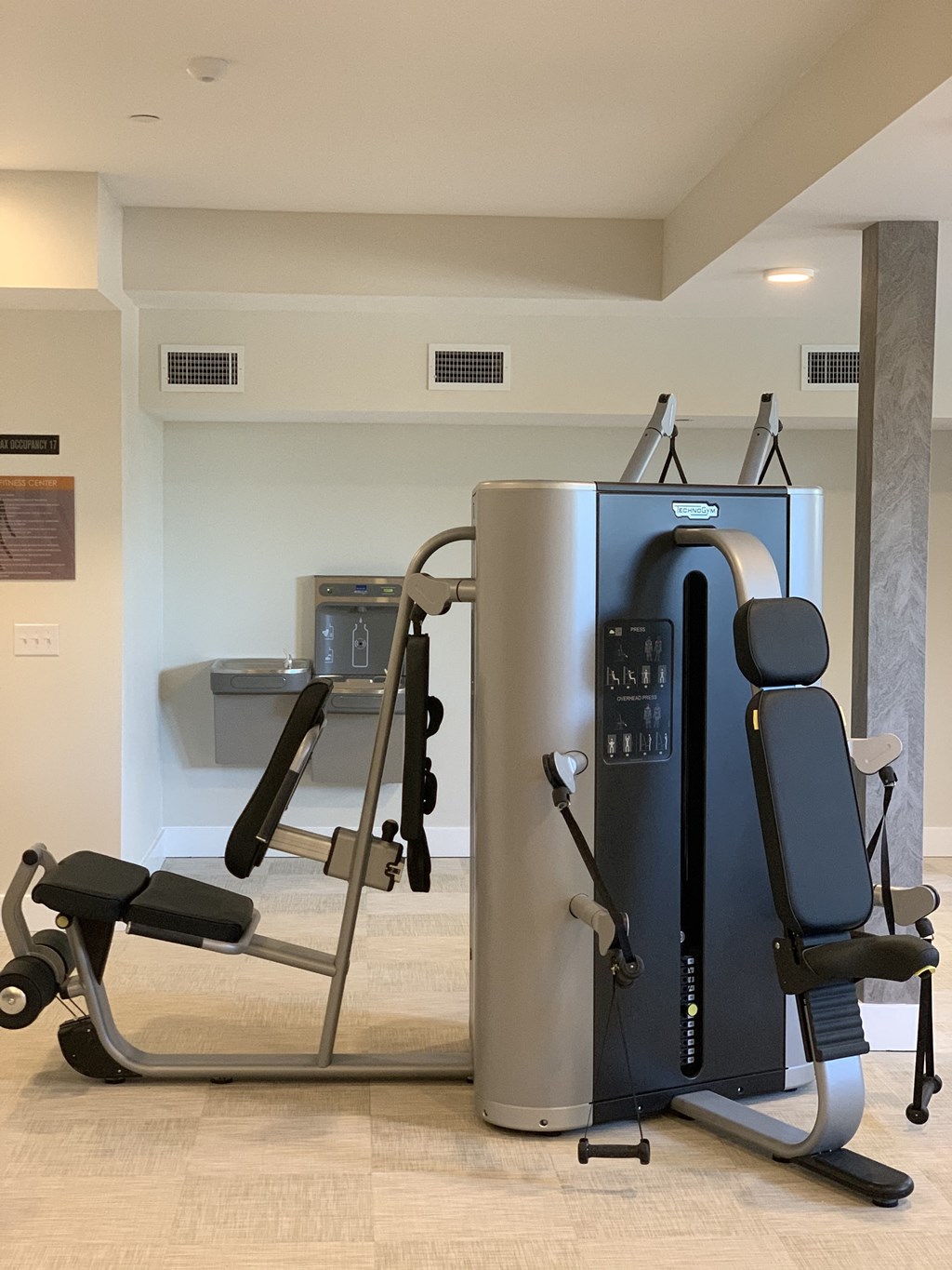 Fitness Center with Chest Machines, Water Fountain, Rules Sign
